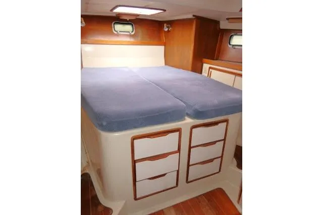 Slide: The Image of Cozy cabin interior of 1988 Irwin 38-2 sailboat with blue cushions and wooden storage. - 22