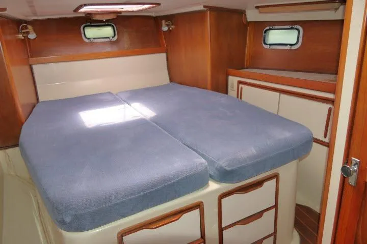 Slide: The Image of Cozy cabin interior of 1988 Irwin 38-2 sailboat with blue bedding and wooden accents. - 23