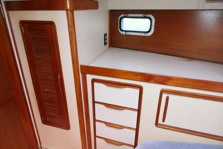 Slide: The Image of Interior of 1988 Irwin 38-2 sailboat with wooden cabinetry and small window. - 25
