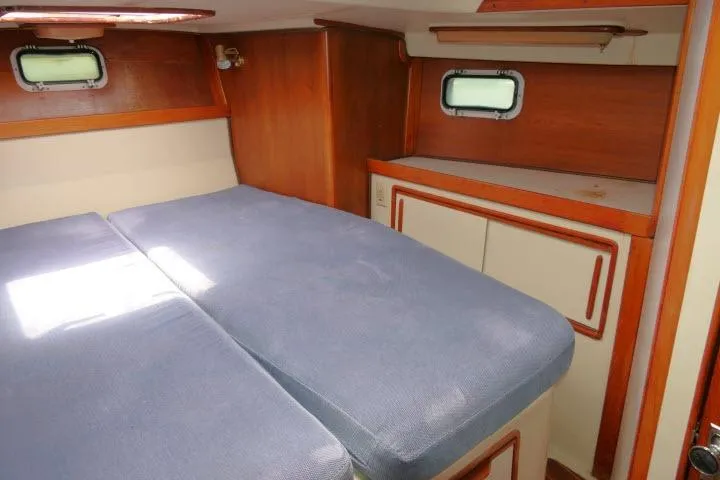 Slide: The Image of Cozy cabin interior of 1988 Irwin 38-2 sailboat with blue bedding and wooden accents. - 27
