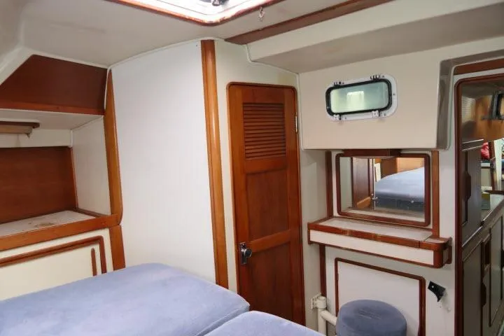 Slide: The Image of Interior of 1988 Irwin 38-2 sailboat with wooden accents and cozy sleeping area. - 28
