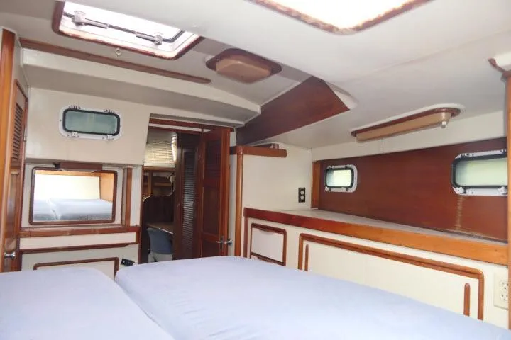 Slide: The Image of Interior of 1988 Irwin 38-2 sailboat cabin with wood accents and portholes. - 29