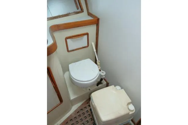 Slide: The Image of 1988 Irwin 38-2 yacht bathroom with toilet and storage compartment. - 31
