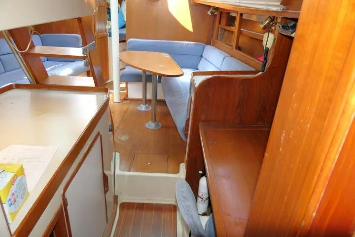 Slide: The Image of Interior of 1988 Irwin 38-2 sailboat with wooden furnishings and blue seating. - 36