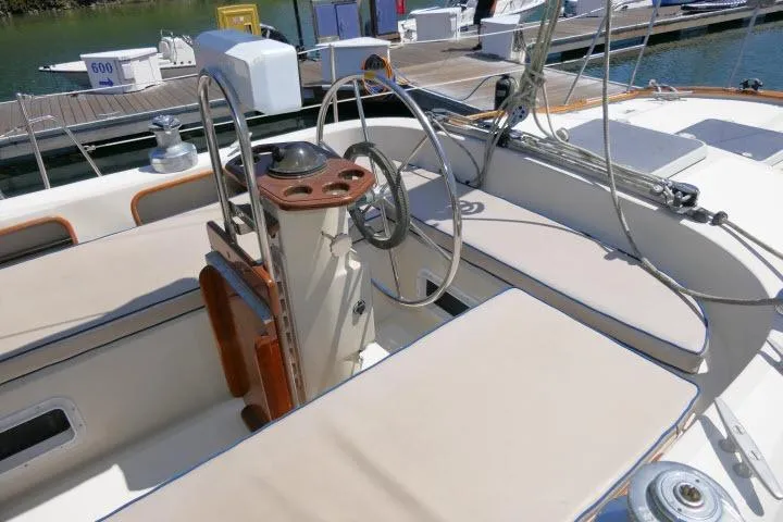 Slide: The Image of Cockpit of a 1988 Irwin 38-2 sailboat with steering wheel and seating. - 38