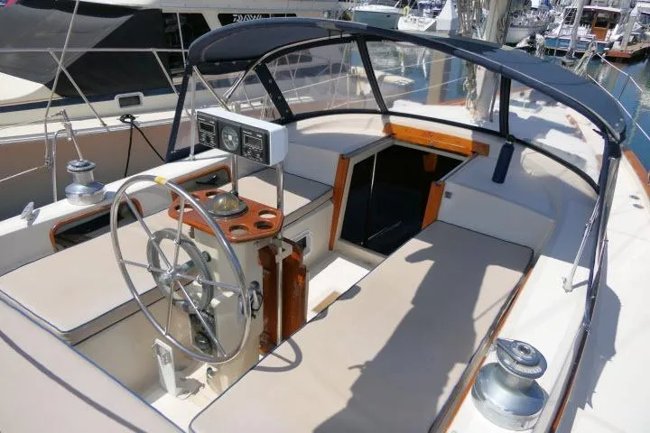 Slide: The Image of Cockpit of 1988 Irwin 38-2 sailboat with steering wheel and navigation instruments. - 39