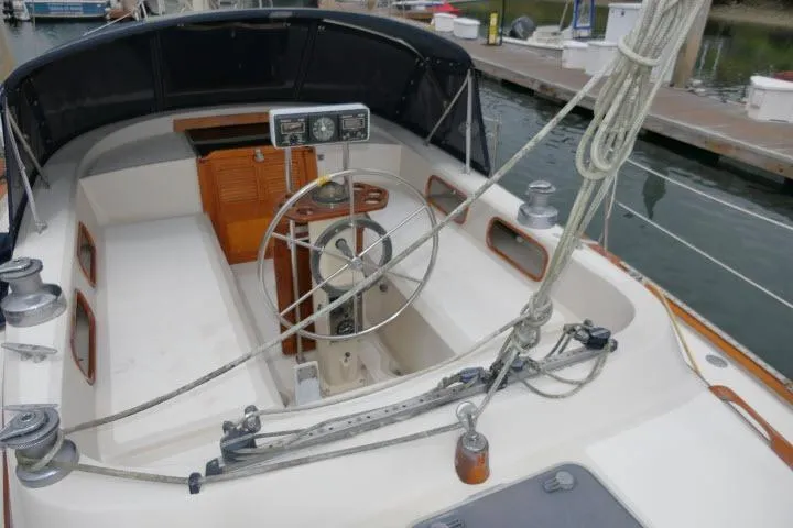 Slide: The Image of 1988 Irwin 38-2 sailboat cockpit with steering wheel and ropes at marina dock. - 41