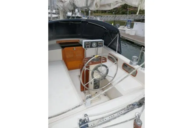 Slide: The Image of Cockpit of 1988 Irwin 38-2 sailboat with steering wheel and navigation instruments. - 42