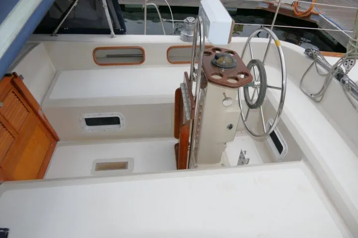 Slide: The Image of Cockpit of 1988 Irwin 38-2 sailboat with steering wheel and wooden accents. - 43