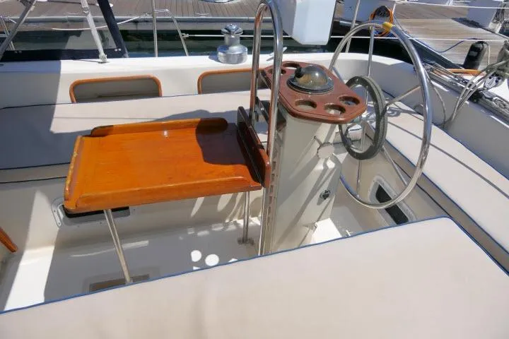 Slide: The Image of Cockpit of 1988 Irwin 38-2 sailboat with wooden table and steering wheel. - 44