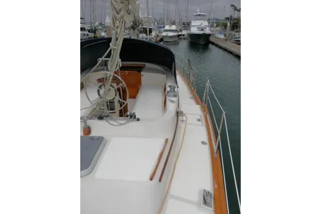 Slide: The Image of 1988 Irwin 38-2 sailboat docked in marina, showcasing deck and rigging. - 46
