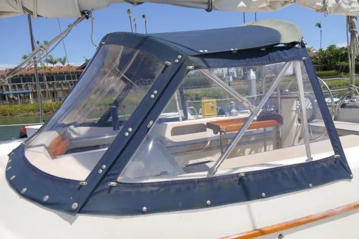 Slide: The Image of 1988 Irwin 38-2 sailboat cockpit with blue canvas cover and clear windows. - 47