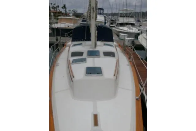 Slide: The Image of 1988 Irwin 38-2 sailboat docked at a marina, showcasing deck and hatch details. - 48