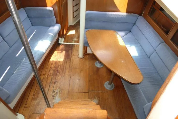 Slide: The Image of Interior of 1988 Irwin 38-2 sailboat with blue seating and wooden table. - 5