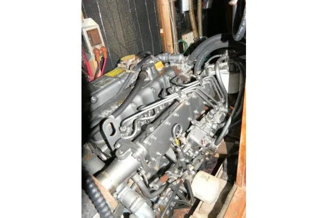 Slide: The Image of 1988 Irwin 38-2 engine compartment with visible mechanical components and wiring. - 50