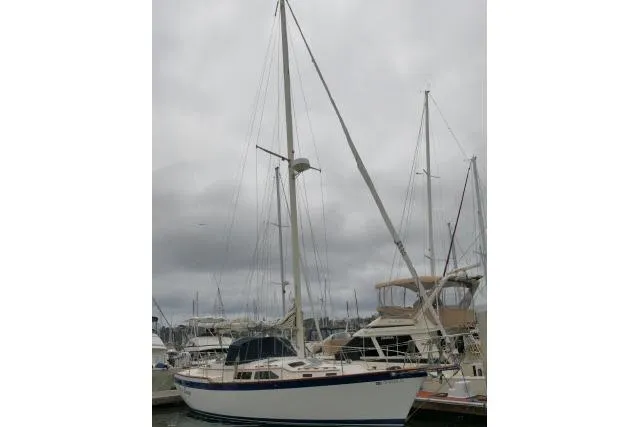 Slide: The Image of 1988 Irwin 38-2 sailboat docked under cloudy skies. - 55