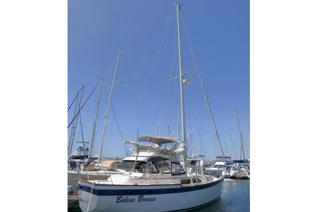 Slide: The Image of 1988 Irwin 38-2 sailboat docked in marina under clear blue sky. - 56