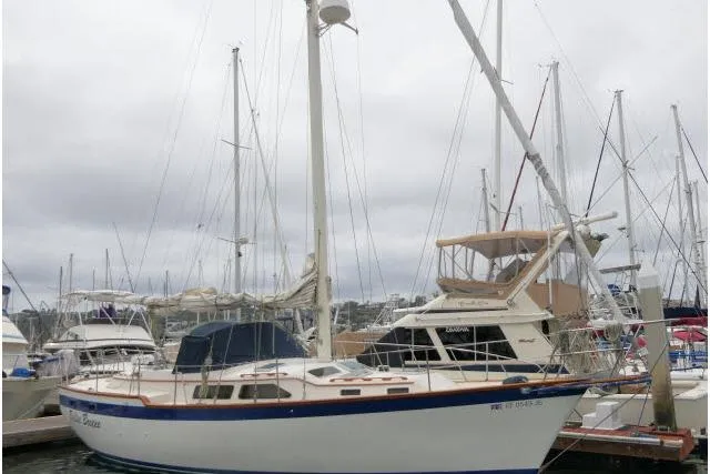 Slide: The Image of 1988 Irwin 38-2 sailboat docked at a marina under cloudy skies. - 61