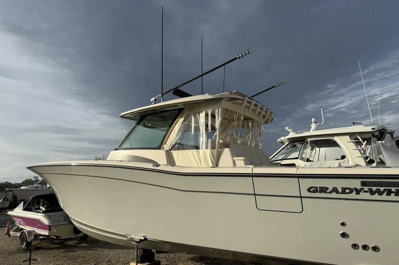 Slide: The Image of 2025 Grady-White Canyon 386 boat with sleek design under cloudy sky. - 15