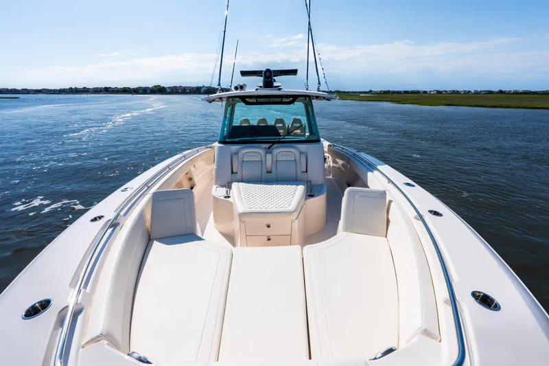 Slide: The Image of 2025 Grady-White Canyon 386 boat cruising on a serene waterway. - 16