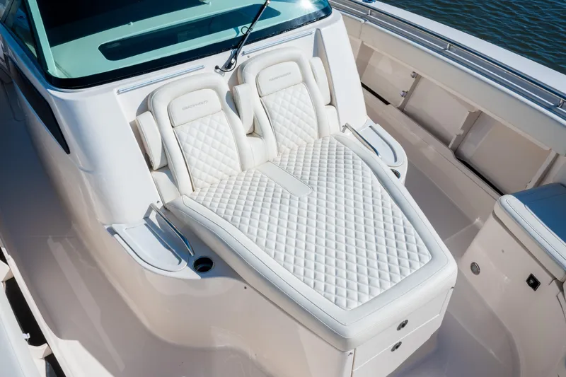 Slide: The Image of Luxurious seating on the 2025 Grady-White Canyon 386 boat, featuring elegant white upholstery. - 18