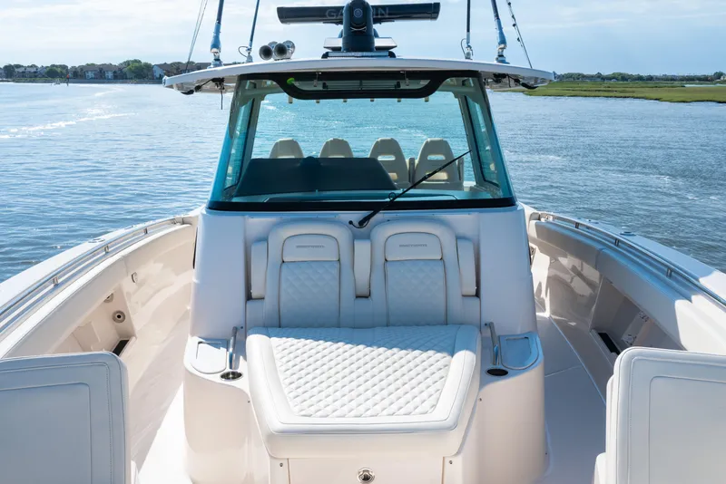 Slide: The Image of 2025 Grady-White Canyon 386 boat interior with luxurious seating on calm water. - 19