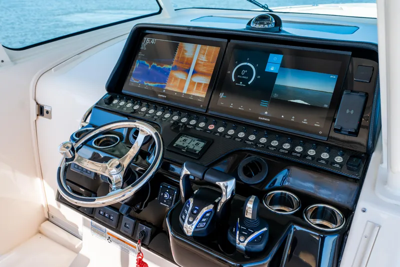 Slide: The Image of Helm of 2025 Grady-White Canyon 386 with advanced navigation displays and controls. - 21
