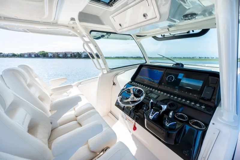 Slide: The Image of Luxurious 2025 Grady-White Canyon 386 boat interior with advanced navigation system and plush seating. - 22