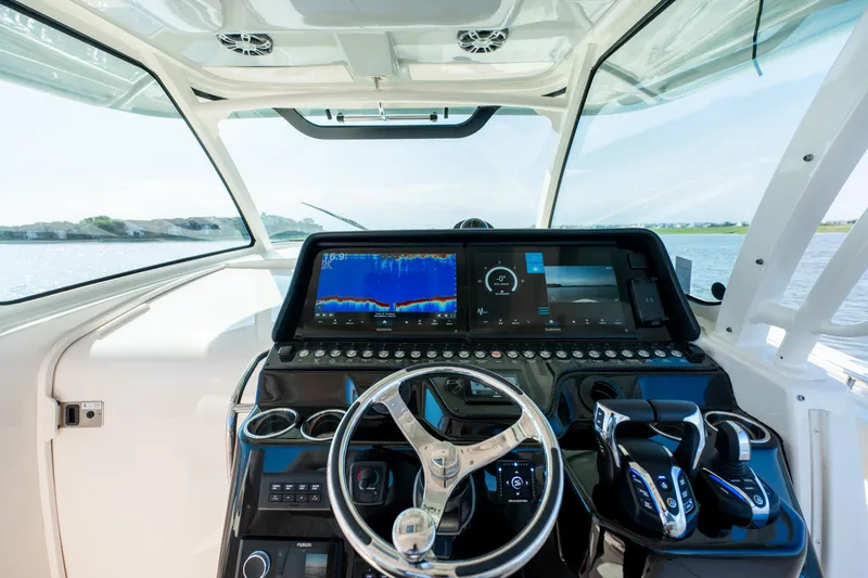 Slide: The Image of Helm of 2025 Grady-White Canyon 386 boat with advanced navigation displays. - 23