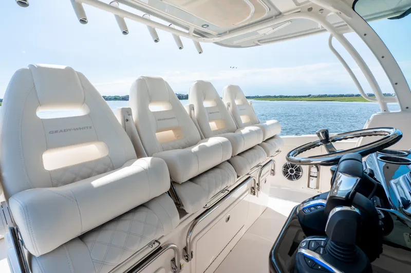 Slide: The Image of 2025 Grady-White Canyon 386 boat interior with luxurious seating and steering wheel. - 24