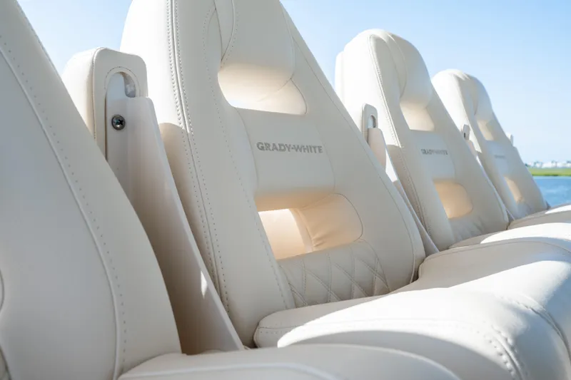 Slide: The Image of Luxurious seating on the 2025 Grady-White Canyon 386 boat, featuring elegant white upholstery. - 26