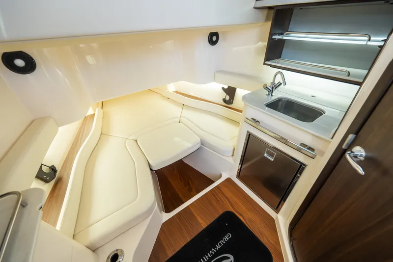 Slide: The Image of Luxurious interior of 2025 Grady-White Canyon 386 boat with kitchenette and seating area. - 28
