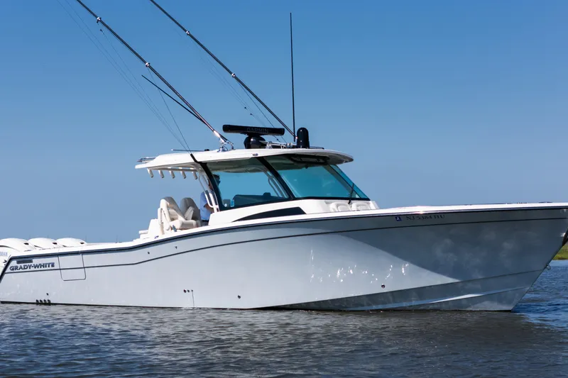 Slide: The Image of 2025 Grady-White Canyon 386 boat on water, featuring sleek design and fishing rods. - 3