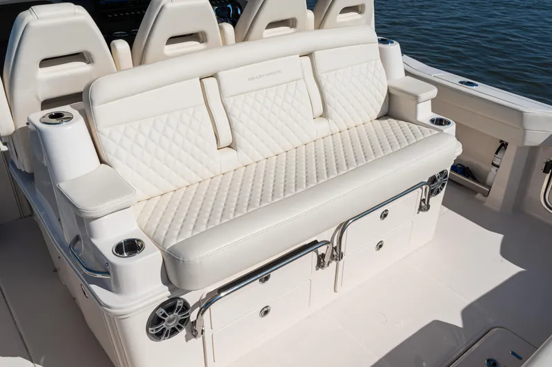 Slide: The Image of Luxurious seating on 2025 Grady-White Canyon 386 boat, featuring quilted upholstery and cup holders. - 33