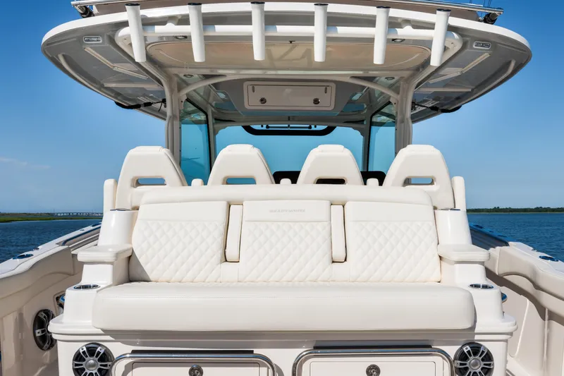 Slide: The Image of 2025 Grady-White Canyon 386 boat interior with luxurious seating and ocean backdrop. - 34