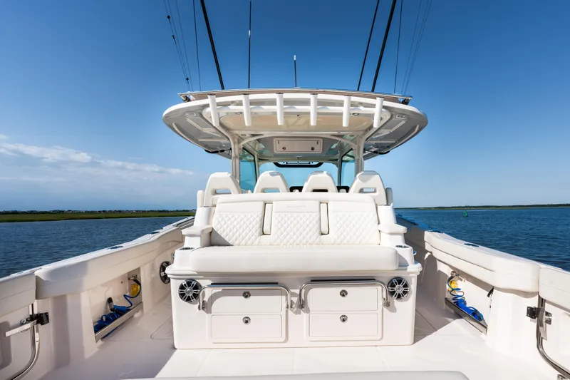 Slide: The Image of 2025 Grady-White Canyon 386 boat interior with seating, ocean view, and clear sky. - 35