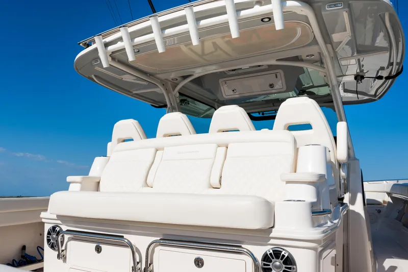 Slide: The Image of 2025 Grady-White Canyon 386 boat interior with luxurious seating under a clear blue sky. - 36