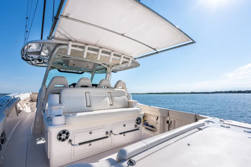 Slide: The Image of 2025 Grady-White Canyon 386 boat interior with seating, under a clear blue sky. - 40