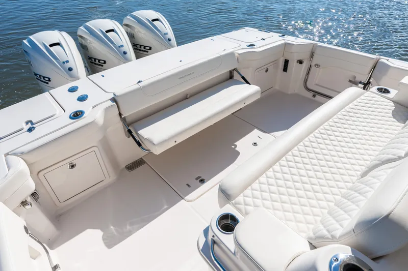 Slide: The Image of 2025 Grady-White Canyon 386 boat interior with luxurious seating and triple outboard engines. - 43