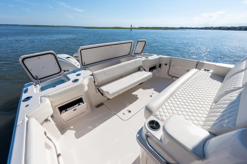 Slide: The Image of 2025 Grady-White Canyon 386 boat interior with luxurious seating and open storage compartments. - 44