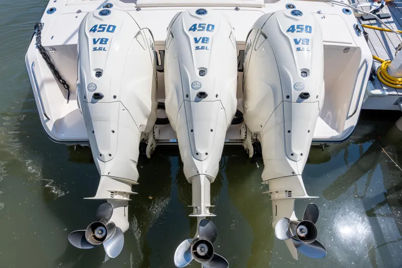Slide: The Image of Triple 450 V8 outboard engines on a 2025 Grady-White Canyon 386 boat. - 48
