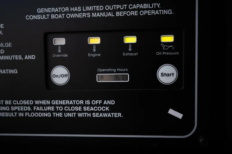 Slide: The Image of Control panel of a 2025 Grady-White Canyon 386 boat, showing generator indicators and operating hours. - 49