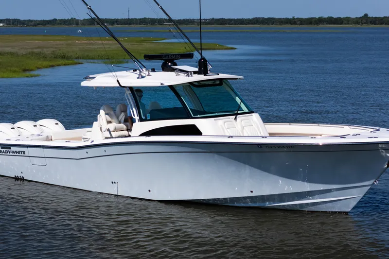 Slide: The Image of 2025 Grady-White Canyon 386 boat on calm water, showcasing sleek design and advanced features. - 5