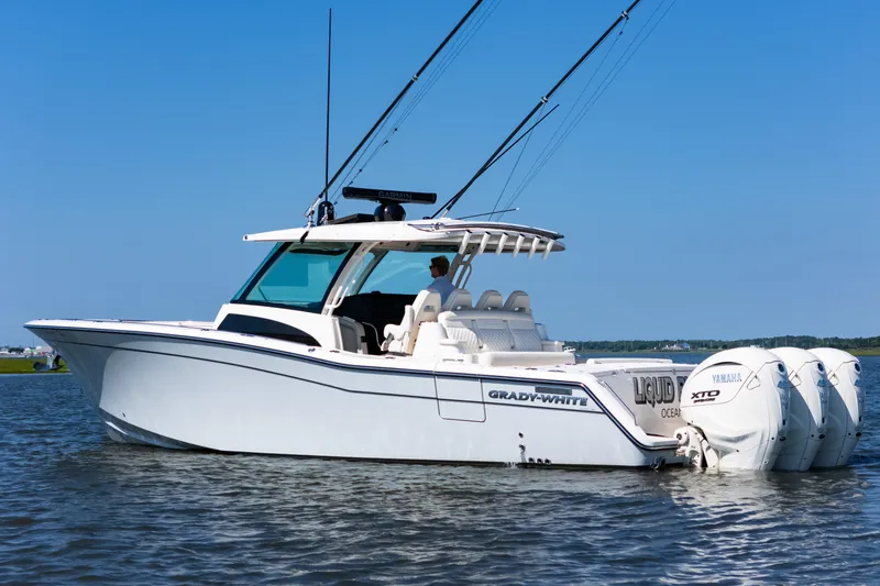 Slide: The Image of 2025 Grady-White Canyon 386 boat on water, featuring Yamaha engines and sleek design. - 8