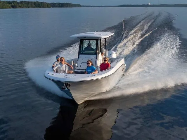 The Image of Stingray 26 CC 2027 cruising on calm water with passengers. - 1