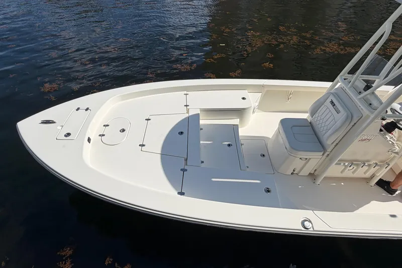 Slide: The Image of 2022 Pathfinder 2600 HPS boat on water, showcasing spacious deck and seating. - 12