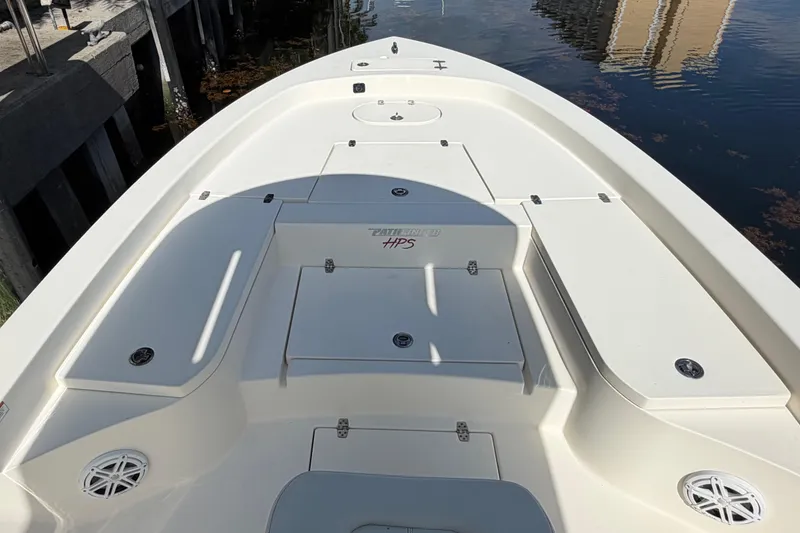 Slide: The Image of 2022 Pathfinder 2600 HPS boat deck, featuring spacious storage compartments and sleek design. - 14