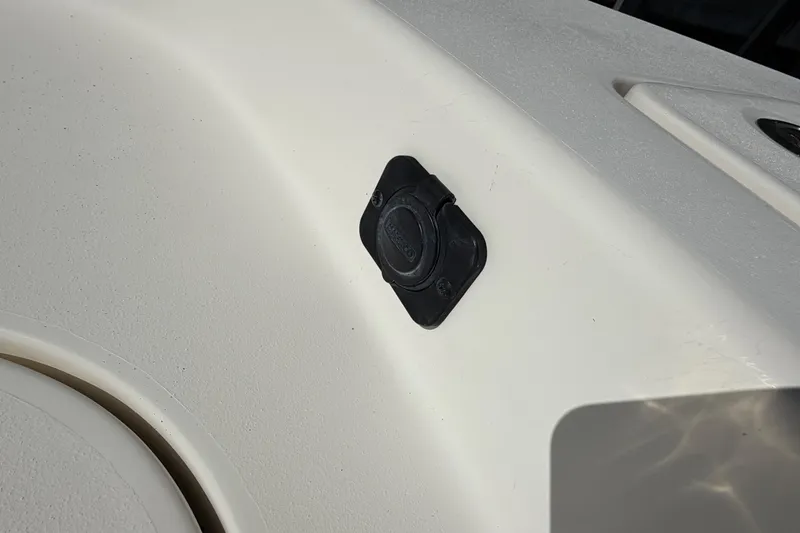 Slide: The Image of 2022 Pathfinder 2600 HPS boat detail showing a black deck fitting on white surface. - 17