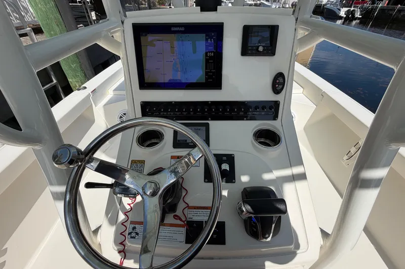 Slide: The Image of 2022 Pathfinder 2600 HPS boat console with steering wheel and navigation display. - 27