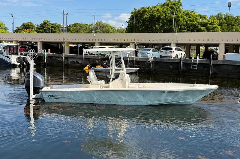 Slide: The Image of 2022 Pathfinder 2600 HPS boat docked in a marina, featuring sleek design and powerful engine. - 3